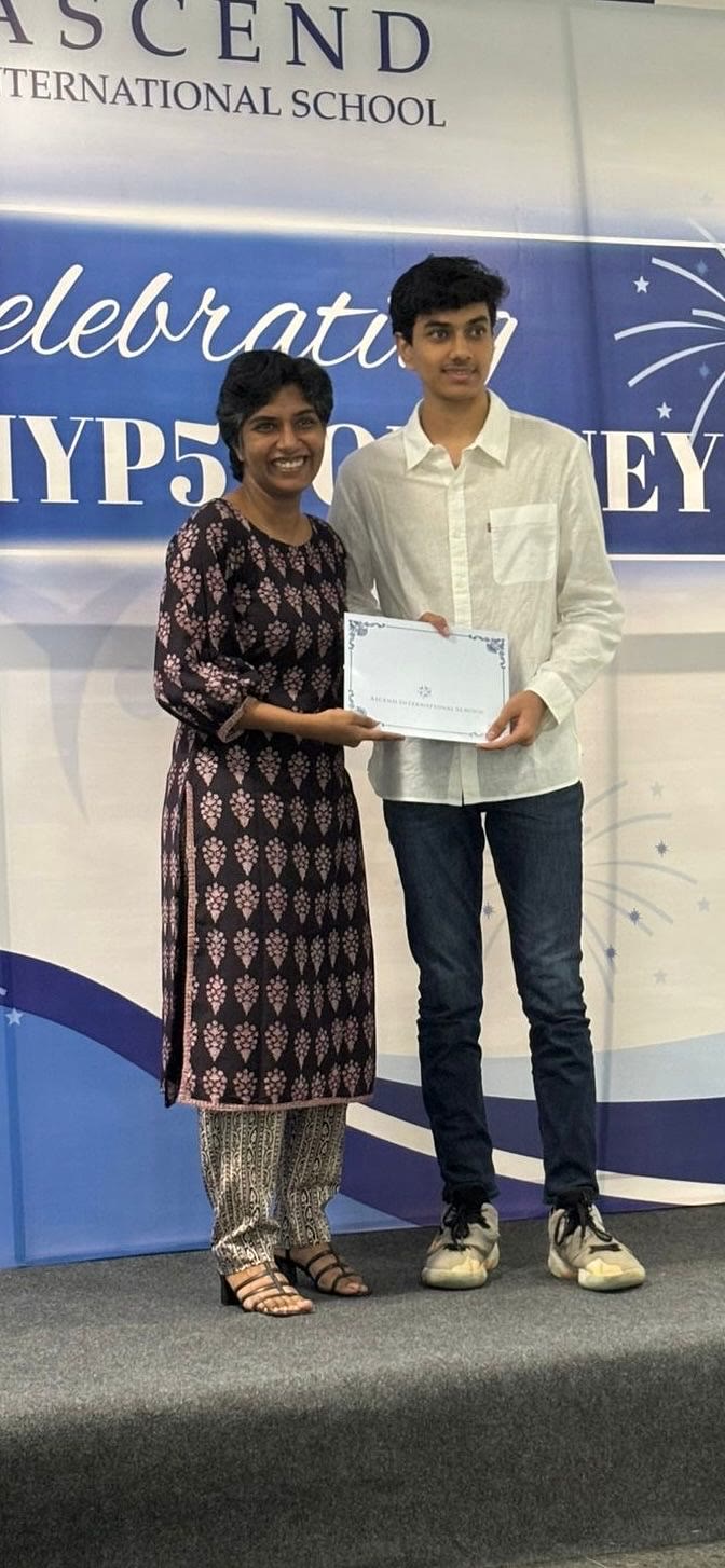 Arjun in a white shirt receives a certificate on a stage with a banner reading Celebrating the MYP5 Journey.